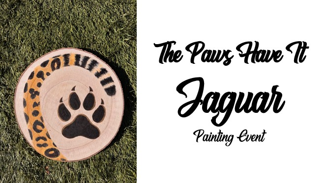A round wood slice with a jaguar paw print and painted jaguar spots rests on grass; text reads "The Paws Have It Jaguar Painting Event." Perfect for any painting event inspired by the majestic jaguar.