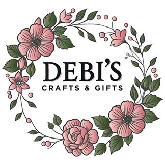 Floral wreath with pink flowers and green leaves surrounds the text "DEBI'S CRAFTS & GIFTS," reminiscent of a tucked-away painting event ready to inspire your creativity.